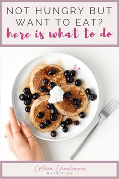 a white plate topped with pancakes covered in blueberries