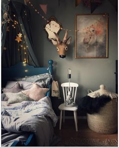 a bed room with a neatly made bed and pictures on the wall