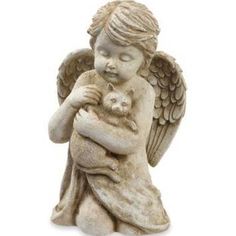 an angel statue holding a cat in its arms