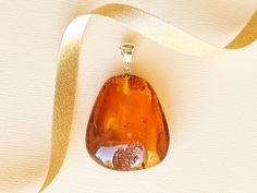 "Golden amber large pendant for untreated, genuine amber admirers. It's a must-have if you know the worth of natural baltic amber handmade jewelry. This clear and light amber stone shines beautifully in every light. MATERIALS AND SIZE: Stone: 100% Natural Baltic Amber Other materials: sterling silver 925 Weight: 18,4 g (0,64 oz) Pendant size: 4,5 cm (1,77 in) x 3,9 cm (1,53 in) Total length: 6,1 cm (2,4 in) PLEASE NOTE: All our amber production is made of natural amber. Amber is an unique stone Baltic Amber Pendant Necklace, Amber Pendant Necklace In Baltic Amber, Oval Baltic Amber Necklace, Teardrop Baltic Amber Necklace In Amber Color, Teardrop Baltic Amber Necklace, Baltic Amber Drop Jewelry As Gift, Baltic Amber Drop Jewelry For Gifts, Baltic Amber Drop Jewelry In Amber, Baltic Amber Drop Jewelry In Amber Color