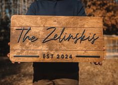 a person holding up a wooden sign that says the zelipspies