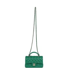 This Mini Rectangular flap bag is in green lambskin with light gold tone hardware and has a front flap with signature CC turnlock closure, rear half moon pocket, top handle and single interwoven green leather and light gold tone chain link shoulder/crossbody strap.The interior is lined in green leather and features a zipper pocket with Chanel pull and an open pocket below.Collection: 24AOrigin: FranceCondition: New and never worn (plastic on hardware)Accompanied by: Chanel box, Chanel dustbag, felt, carebook, retail UPC and ribbonMeasurements: 8.5" width x 6" height x 3" depth; 1.77" top handle, 22.5" strap drop Green Evening Bag With Double Flap, Green Double Flap Evening Bag, Green Leather Shoulder Bag With Turn-lock Closure, Designer Green Double Flap Bag, Formal Green Bag With Turn-lock Closure, Luxury Green Rectangular Flap Bag, Luxury Green Top Handle Flap Bag, Luxury Green Flap Bag With Detachable Handle, Green Leather Double Flap Bag