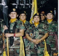 some women in uniform are posing for a photo