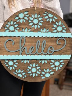 a wooden sign with the word hello painted on it