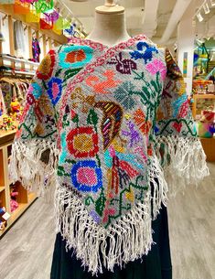 These beautiful Mexican ponchos (aka mañanitas) are handmade in Hueyapan Puebla. Every poncho bears unique hand-embroidery according to the traditions of the community. Measuring approximately 34" wide by 26'' long, one size should fit all adults. All ponchos can be worn 2 ways: Flat across the front or point down, for a longer, more flowing look. Traditional Handwoven Poncho For Fall, Folk Style Festival Poncho One Size, Handwoven Festival Poncho Shawl, Handwoven Poncho Shawl For Festivals, Handmade Artisan Poncho For Festivals, Winter Festival Embroidered Poncho, Handwoven Folk Shawl One Size, Folk Style Handwoven Shawl, Bohemian Embroidered Festival Poncho