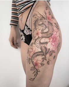 a woman's thigh with tattoos on it