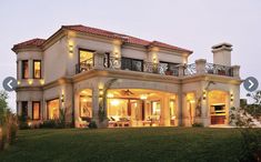 a large house lit up at night in the evening