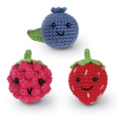 three crocheted fruits with faces on them