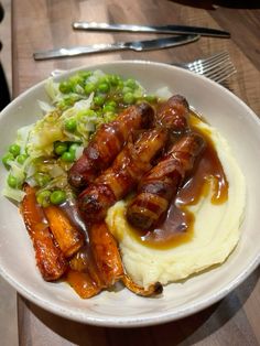 a white plate topped with mashed potatoes and meat