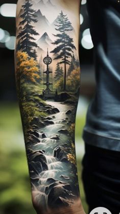 a person with a tattoo on their arm that has trees and mountains in the background