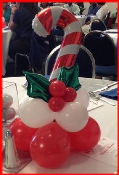 a candy cane and balloon decoration on a table