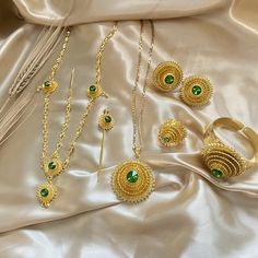 A classic set throughout Habesha culture and worn by women for weddings, baptisms, graduation ceremonies, religious holidays, and many other special occasions. This Eden Werki Set is perfect to wear as a complete set or worn individually to accentuate your habesha kemis for any special occasion. *Please email MyMeskel@gmail.com to order multiple sets for bridal parties All Gold Plated Jewelry 6-piece set includes: Necklace, earrings, ring, bracelet, headpiece, and hair pin Pendant Size: 4.5cm (1 Ethiopian Jewelry Ethiopian Clothing, Ethiopian Gold Jewelry, Ethiopian Headpiece, Eritrean Braids, Habesha Culture, Arab Jewelry, Ethiopian Wedding, Ethiopian Jewelry, Ethiopian Dress