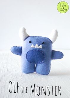 a blue stuffed animal with horns on it's head and the words, off the monster