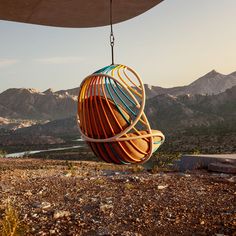 a colorful object hanging from the side of a mountain