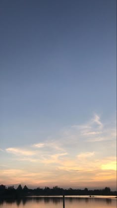 the sky is reflecting in the water at sunset