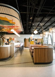 the interior of a restaurant with tables and chairs