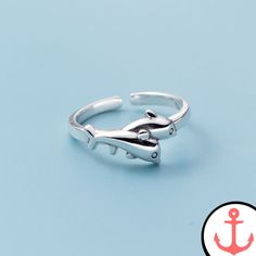 Mood Ring With Dolphins: Embrace the Enchanting Beauty of the Sea Transport yourself to the mesmerizing depths of the ocean with our exquisite Mood Ring With Dolphins. Crafted with passion and precision, this nautical-themed ring is the perfect embodiment of your love for the sea and its majestic creatures. As passionate sea lovers ourselves, we understand the allure of marine animals and nautical symbols. That's why we have curated an entire Dolphin Ring Collection that captures the essence of Ocean-inspired Promise Ring, Adjustable Silver Rings With Ocean-inspired Style, Adjustable Silver Ocean-inspired Rings, Silver Nautical Rings As Gifts, Silver Nautical Rings For Gift, Silver Nautical Style Ring As A Gift, Nautical Style Silver Rings For Gift, Nautical Symbols, Dolphin Ring