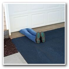 a pair of shoes that are sitting on the ground in front of a garage door