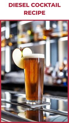 an apple sitting on top of a table next to a tall glass filled with liquid