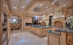 a large kitchen with an island and chandelier