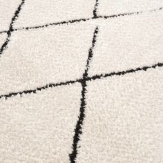 a white rug with black squares on it