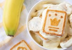 a bowl filled with banana slices and some kind of food on top of a table