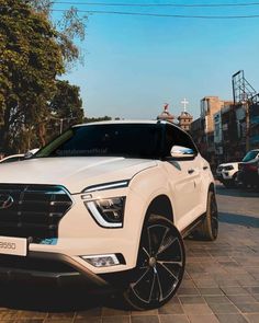 a white suv parked on the side of a road