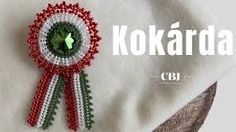 a brooch with a green leaf on it and the words kokarda in spanish