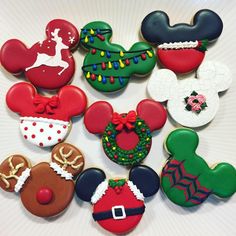 some decorated cookies are arranged in the shape of mickey mouses and christmas wreaths