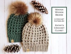 two knitted hats with pom - poms and pine cones next to each other