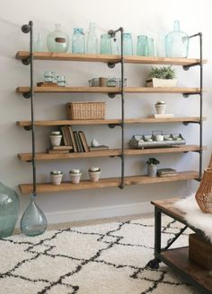 a room with shelves filled with vases and other items on top of each shelf