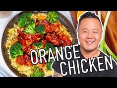 an image of a man with orange chicken and broccoli on a plate in front of him