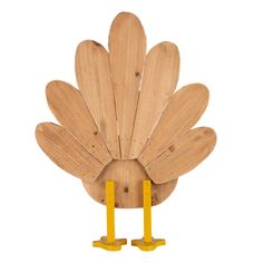 a wooden turkey with two yellow legs