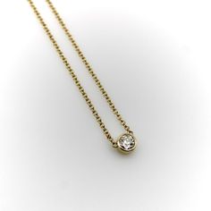 This 14k gold diamond necklace is a classic everyday piece and a great staple for any jewelry collection. The Old European Cut diamond has a lot of sparkle—its facets create excellent light play that pops when worn. The bezel setting is simple and the width of the chain balances the diamond well. This is a vintage piece, circa 1990’s, that contains a much older antique diamond. The perfect combination of old and new.  The natural antique diamond is Old European Cut, VS2 in clarity and I-J in color. It measures 5 mm across and weighs approximately .4 of a carat.   The chain measures 16 1/4”. It is marked 14k, ITALY, and with the maker’s mark “Fancy”. The necklace weighs 2.8 grams. Chanel Pendant, Purple Pendant Necklace, Art Deco Pendant Necklace, Black Pendant Necklace, Blue Pendant Necklace, White Gold Pendant Necklace, Sapphire Necklace Pendants, Gold Diamond Necklace, Modern Necklaces