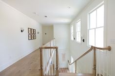 an empty room with stairs and pictures on the wall