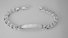 "This solid sterling silver bracelet is 8\" long and features a flat, diamond cut curb chain with a lobster claw clasp. The engravable identification plate is about 1.5\" long and a bit over .25\" wide and about 1/8\" thick. This is a heavy bracelet, weighing about 32 g. It has a high polish, shiny finish These look fabulous with a name, initials, a date or even Roman numerals. Delivered to you in a gift box. To see my current selection of bracelets: https://www.etsy.com/shop/AnniesHours?section Elegant Sterling Silver Bracelets With Curb Chain, Classic Adjustable Curb Chain Jewelry, Classic Engraved Oval Link Chain Bracelet, Elegant Personalized Curb Chain Jewelry, Classic Engraved White Gold Chain Bracelet, Elegant Curb Chain Jewelry For Personalized Gift, Elegant Jewelry With Curb Chain For Personalized Gift, Silver Hallmarked Nameplate Jewelry, Engraved Silver Nameplate Jewelry