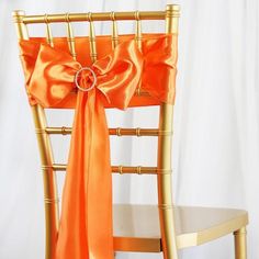 an orange chair sash tied to the back of a gold chair