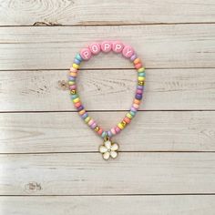 This is a PERFECT kids gift! This flower charm bracelet has petite pastel beads and a cute white flower charm! Kids love custom gifts, made just for them. Personalize it with any name in PINK letter bead 💗 🤍 Please check all selections and spelling prior to check out. Our custom bracelets are made to order so all sales are final. 🤍 The bracelets are beautifully packaged and ready to gift. Receipts are never included. If you want to include a special note, please let me know in the comments. ? Cute Name Bracelet With Colorful Beads, Flower-shaped Friendship Bracelets With Letter Beads As Gifts, Flower-shaped Friendship Bracelets With Letter Beads, Cute White Charm Bracelet With Colorful Beads, Pink Flower-shaped Bracelet With Letter Beads, Pink Flower Shaped Beaded Bracelet For Birthday, Playful Pink Flower Bracelets, Cute White Name Bracelet With Colorful Beads, Playful Pink Letter Beads Charm Bracelet