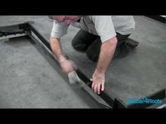 a man bending over to inspect the underside of a metal bed frame with his hands