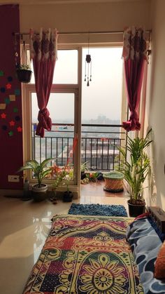 a living room filled with lots of furniture next to a large open window overlooking the ocean