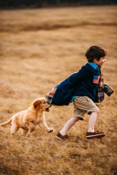 a young boy is running with his dog