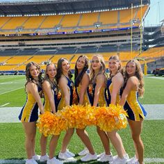 the cheerleaders are posing for a photo on the field