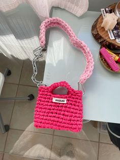 a pink purse sitting on top of a table