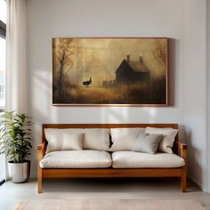 a painting hanging on the wall above a couch in a living room with white walls