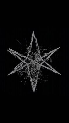 a black and white photo of an inverted star on a dark background with some scratches