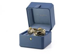 The hinged bracelet, depicting a series of leopard paws with black enamel spots, in 18k gold, the bracelet top accented by diamond set claws, in platinum. Signed David Webb. Includes manufacturer's box and paperwork. The retail price in 2017 was $63,000. Luxury Hinged Jewelry For Gifts, David Webb, Gold Pin, Jewellery Marketing, Tiger Stripes, Hinged Bracelet, Domed Ring, Black Enamel, Diamond Earrings