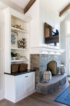 a living room filled with furniture and a flat screen tv mounted above a fire place