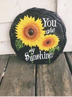 a stone with two sunflowers painted on it that says you are my sunshine