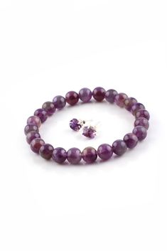 This Amethyst Round Bead Bracelet is stretchy to fit most wrists. This bracelet is great worn alone and really comes to life when stacked with other bead or chain bracelets. It is so affordable you can collect several crystal bead bracelets featured on our site. Natural Unpolished Amethyst Stud Earrings are included. Wouldn't this little bracelet set make a perfect gift? Amethyst is a type of purple quartz with an interesting history. The use of Amethyst can be traced as far back as 25,000 B.C. Round Amethyst Bracelets With 8mm Beads, Amethyst Bracelet With 8mm Beads, Purple Amethyst Bracelets With Round Beads, Classic Amethyst Purple Bracelets, Purple Amethyst Round Beads Bracelet, Crystal Bead Bracelets, Amethyst Bracelet Beads, Amethyst Studs, Purple Quartz