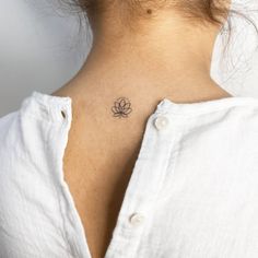 a woman with a small tattoo on her neck